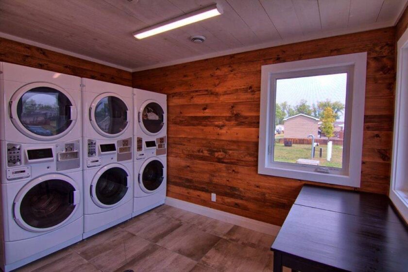 Shared guest laundry room with coin-operated washers and dryers at Bellmere Winds Golf Resort, Rice Lake