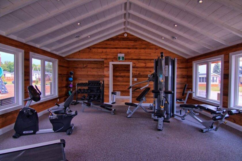 Fitness centre with cardio machines, free weights, and strength equipment at Bellmere Winds Golf Resort, Rice Lake