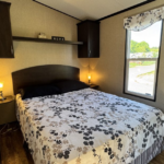 Master bedroom with queen bed at Mildred's Lakefront Resort Cottage, Bellmere Winds Golf Resort on Rice Lake